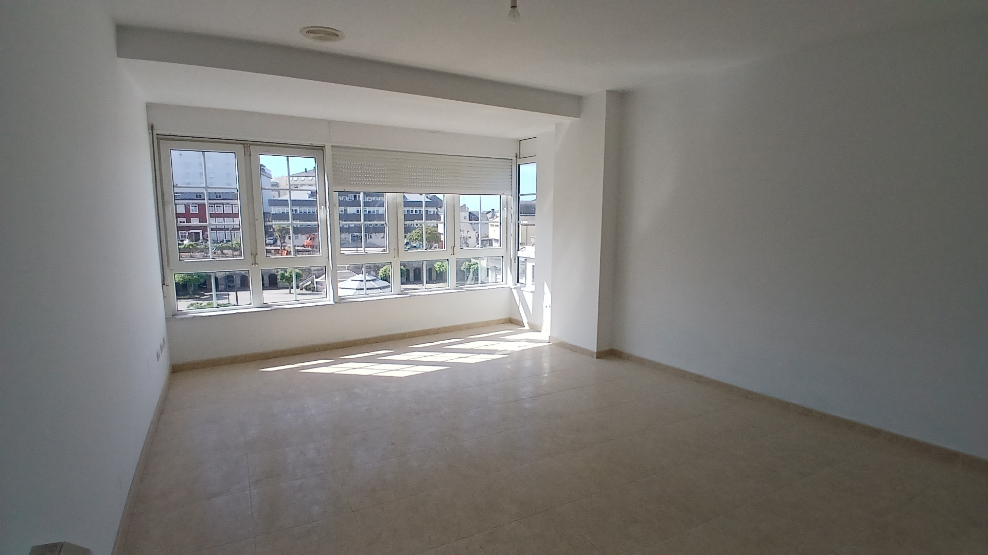 Bright apartment living space with plaza-facing windows