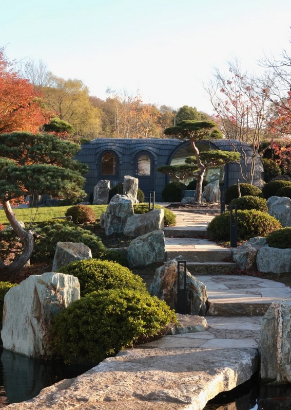 Shingled pavilion set into a Japanese-style garden