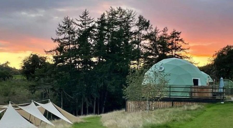 Luxury glamping dome at sunset
