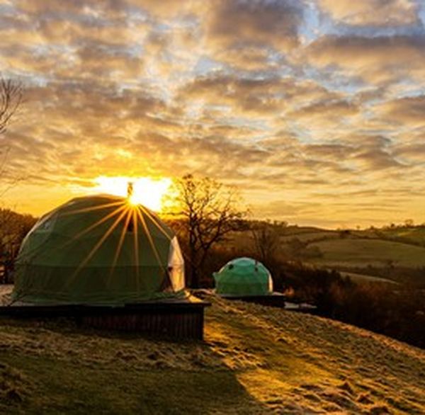 Luxury glamping dome at sunset